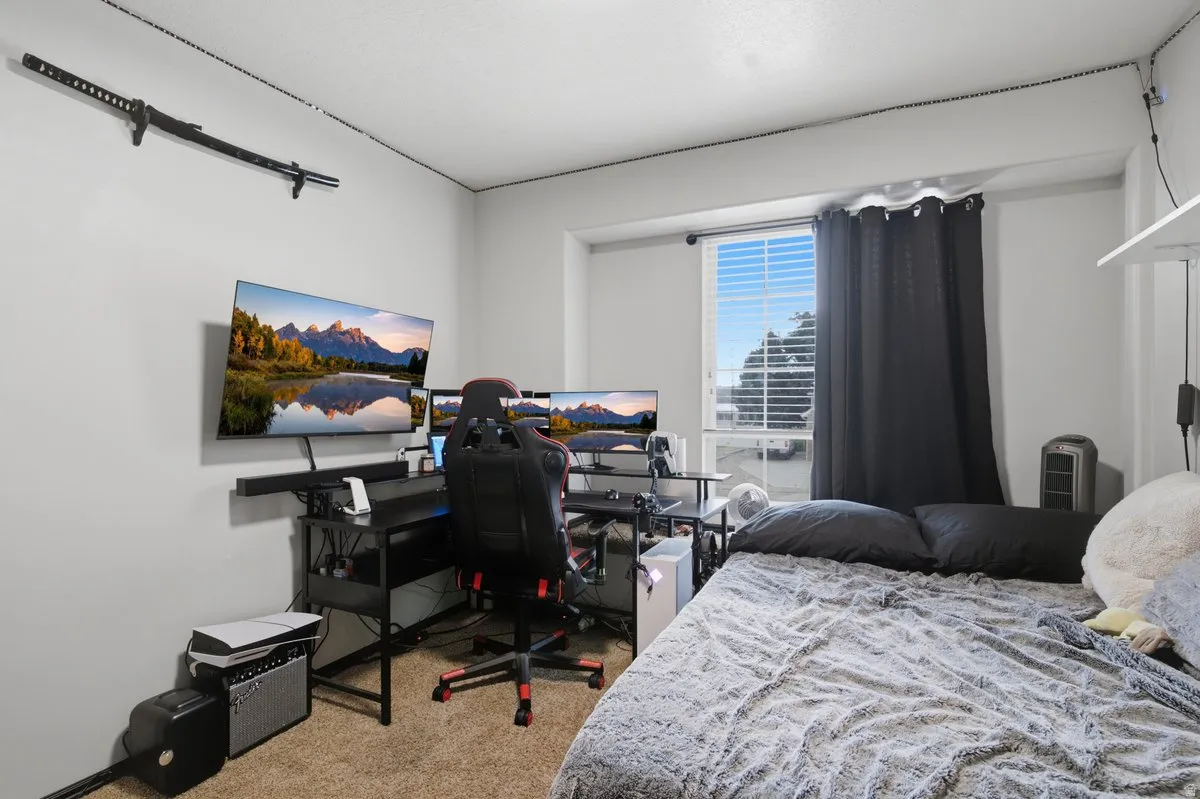 Carpeted flooring, window with horizontal blinds, wall-mounted shelving