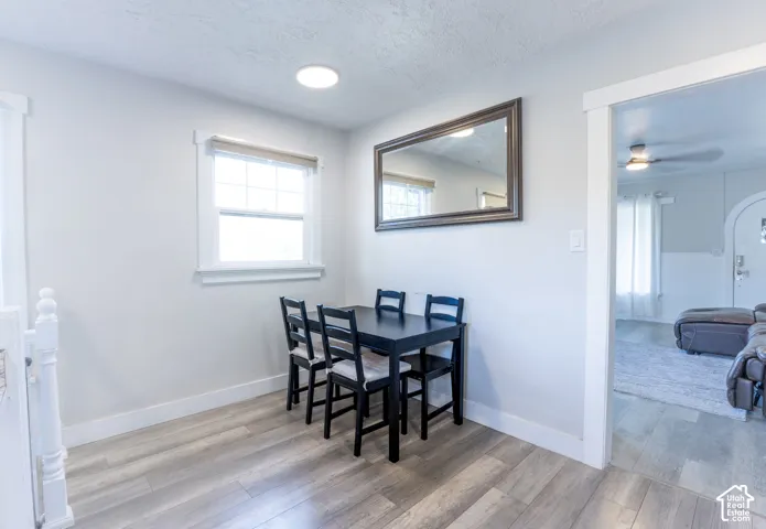 Light gray walls with a white framed window, wood-finish flooring, and recessed ceiling lighting