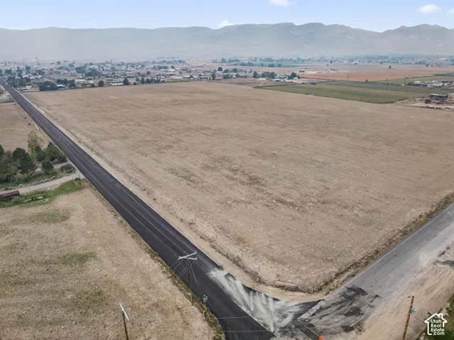 Expansive vacant land parcel featuring a paved roadway