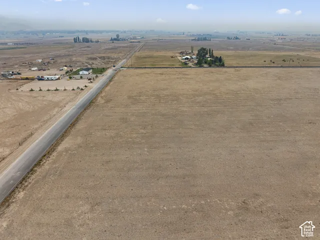 Extensive undeveloped land parcel featuring a paved road frontage