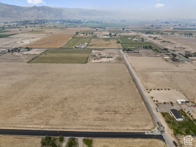 Expansive land parcel with surrounding agricultural fields and distant mountain ranges