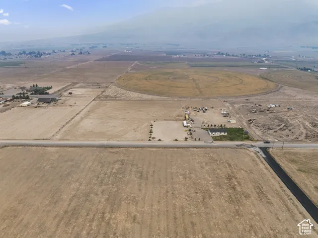 Expansive agricultural land featuring a central pivot irrigation system