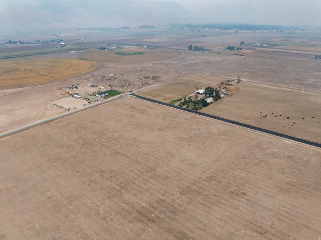 Expansive open acreage featuring cleared land and a paved road