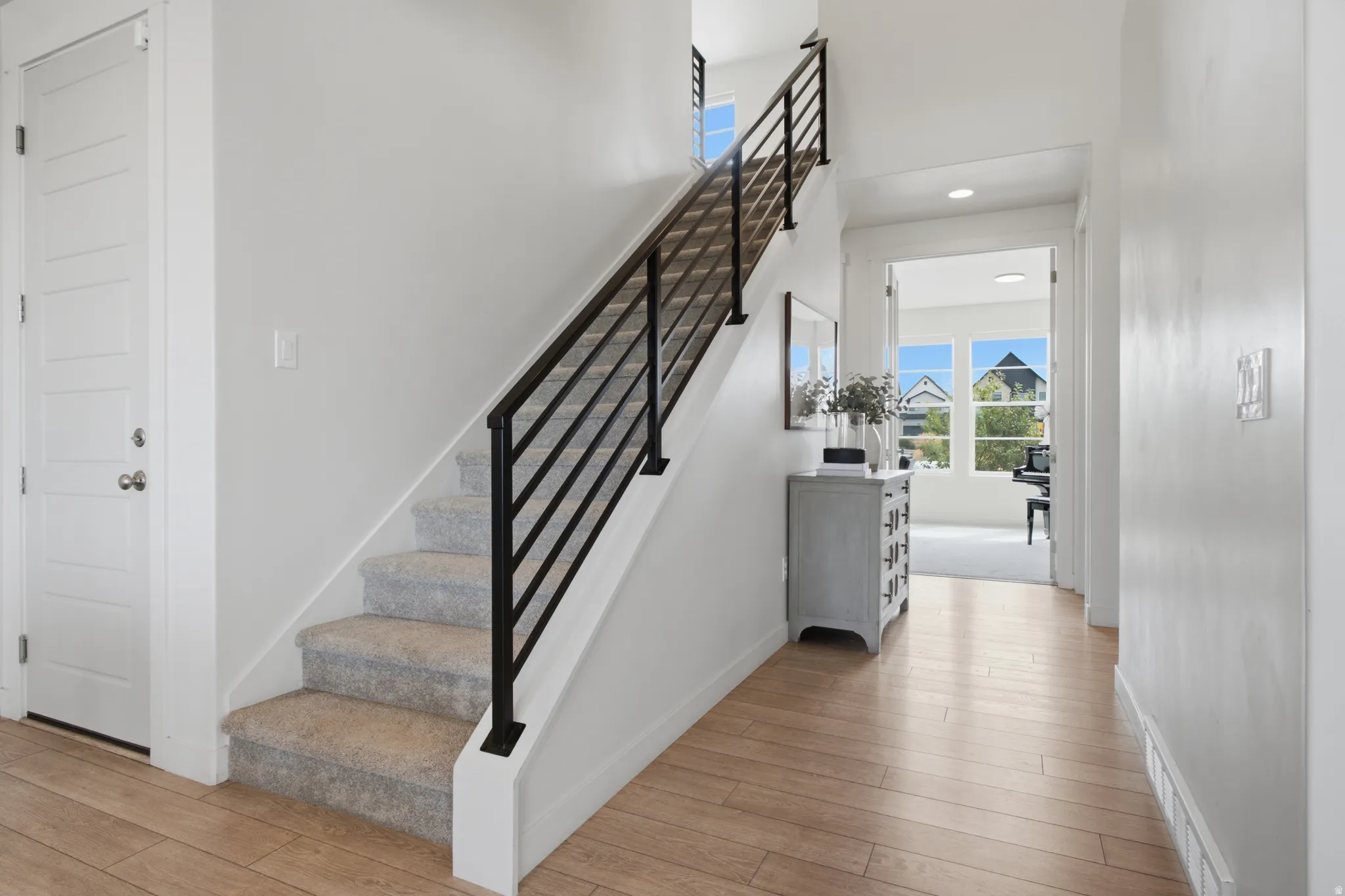Light wood-finish flooring with white walls