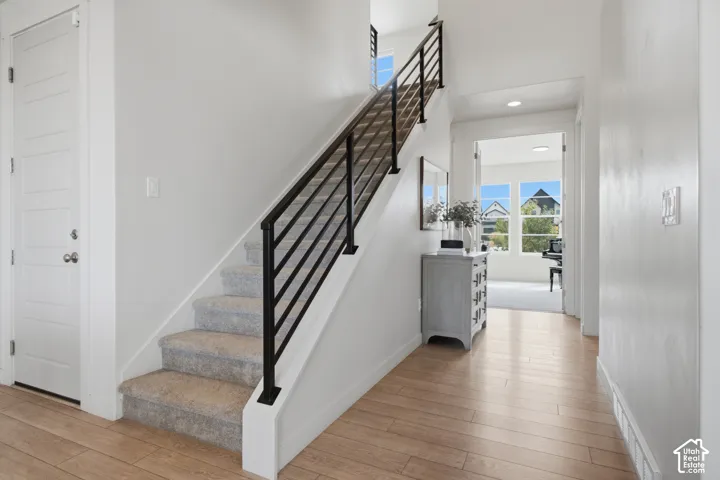 Light wood-finish flooring with white walls