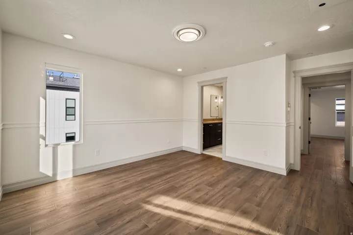 Wood-finish flooring with white walls and wainscoting