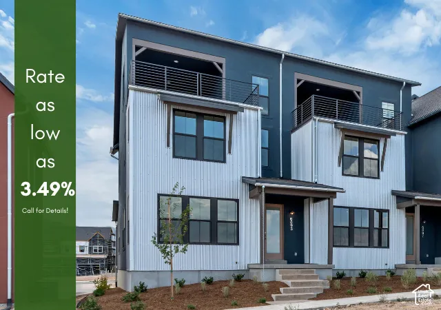 Modern multi-story exterior with corrugated metal and dark panel siding