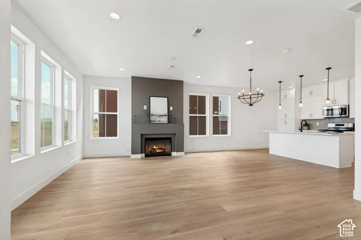 Wood-finish flooring throughout, recessed lighting, and multiple windows