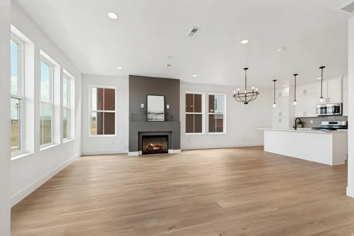 Wood-finish flooring throughout, recessed lighting, and multiple windows