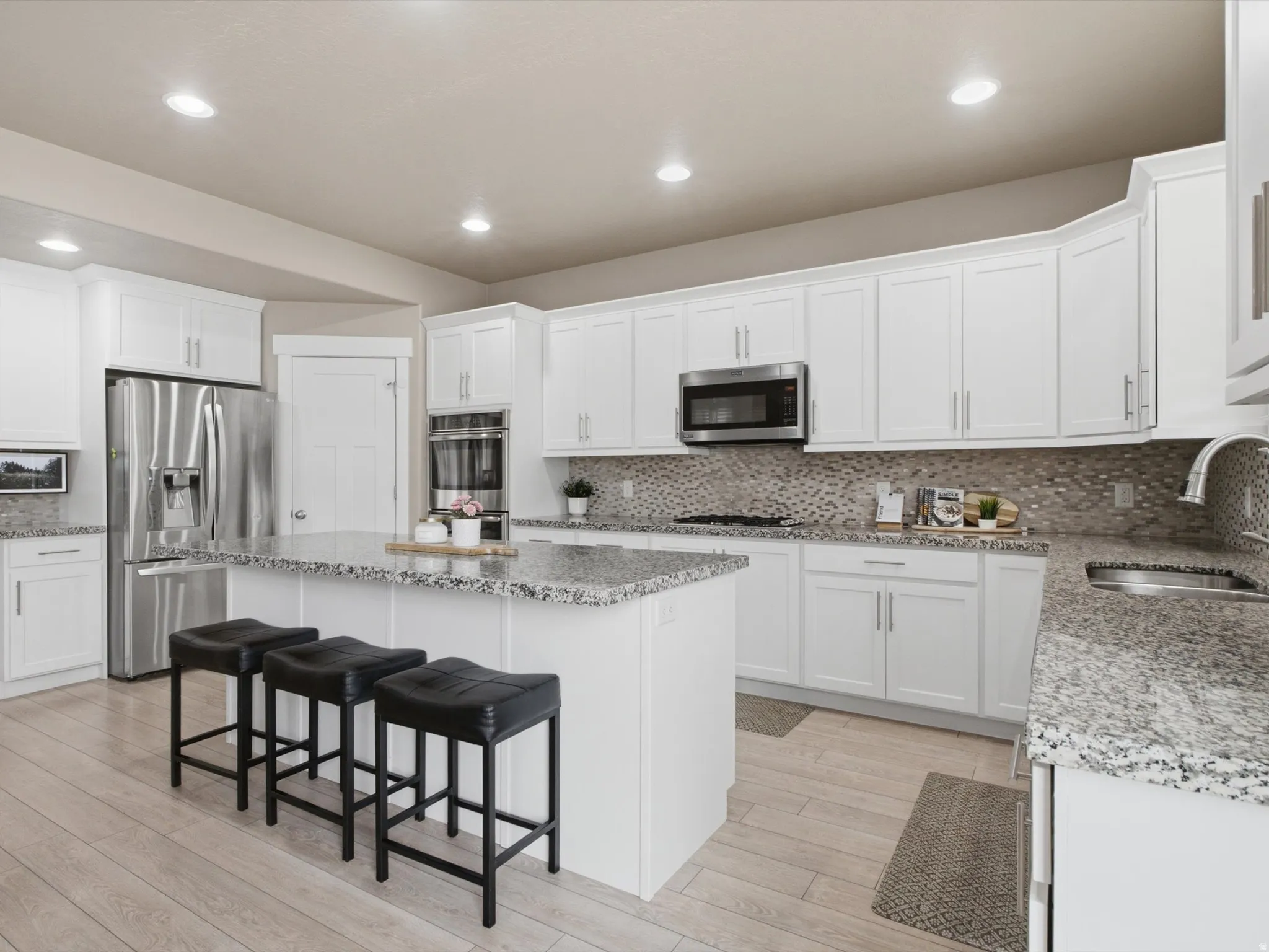 Gourmet kitchen with GRANITE COUNTERTOPS and plenty of prep space.