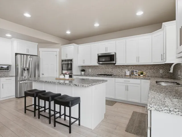 Gourmet kitchen with GRANITE COUNTERTOPS and plenty of prep space.