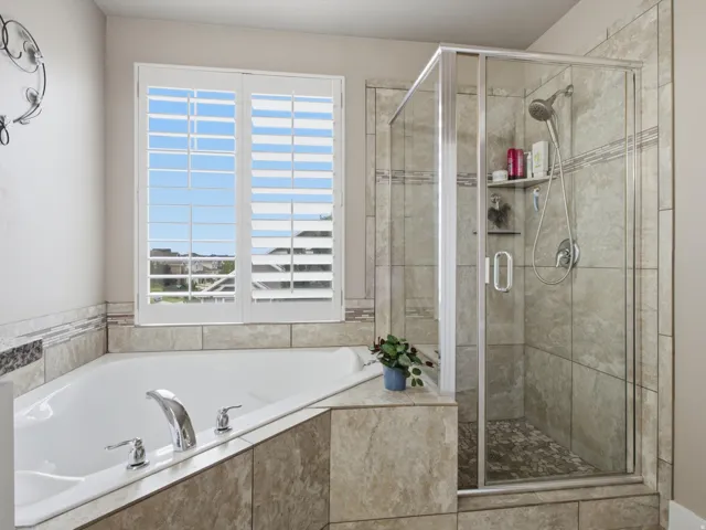 Corner soaking tub with polished chrome fixtures