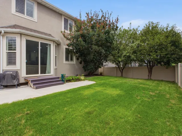 Spacious and fully fenced yard with mature trees.