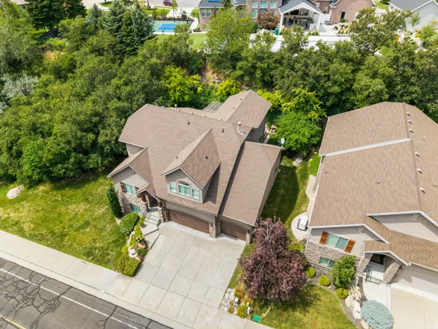 Stone facade residence with a multi-gabled roof and an attached garage
