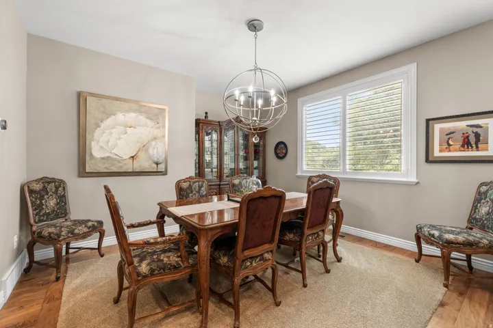 Recessed lighting, wood-finish flooring, and white trim