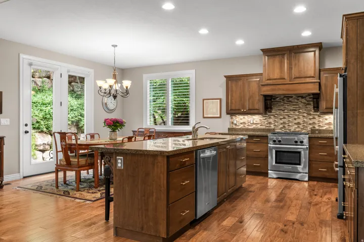 Hardwood flooring, wood cabinetry, granite countertops, stainless steel appliances, and French doors