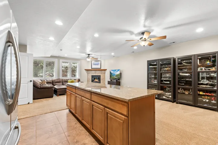 Central island with wood cabinetry and stone-finish countertop