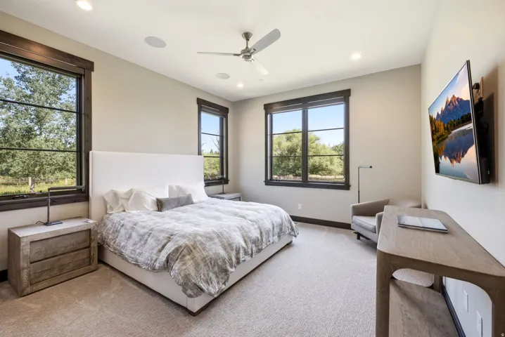 Recessed ceiling lighting, ceiling-mounted speakers, and a ceiling fan