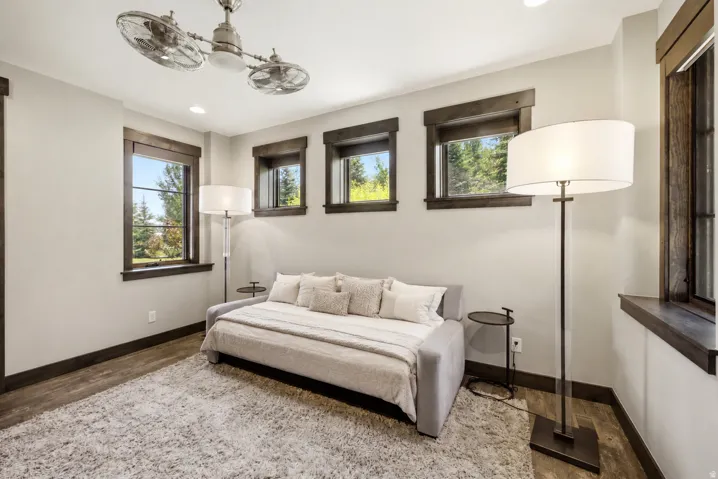Wood-finish flooring, recessed lighting, and dark-trimmed windows