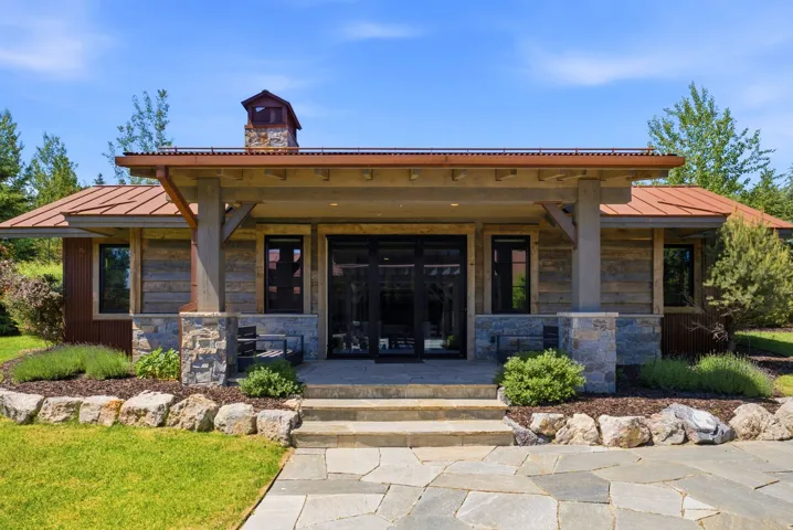 Stone and wood-finish exterior with a covered entry