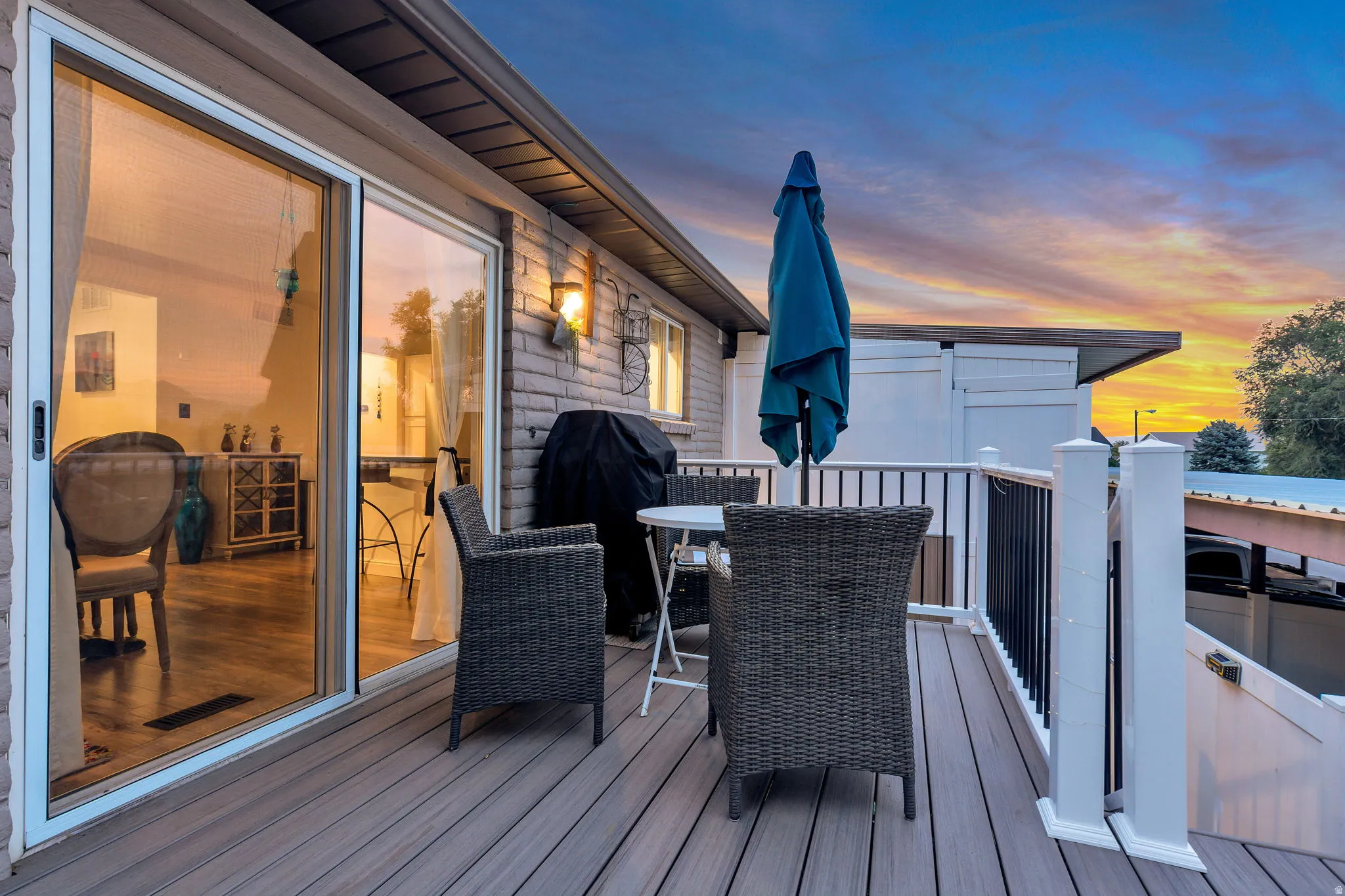 Spacious deck with composite decking, white posts, and black metal railings