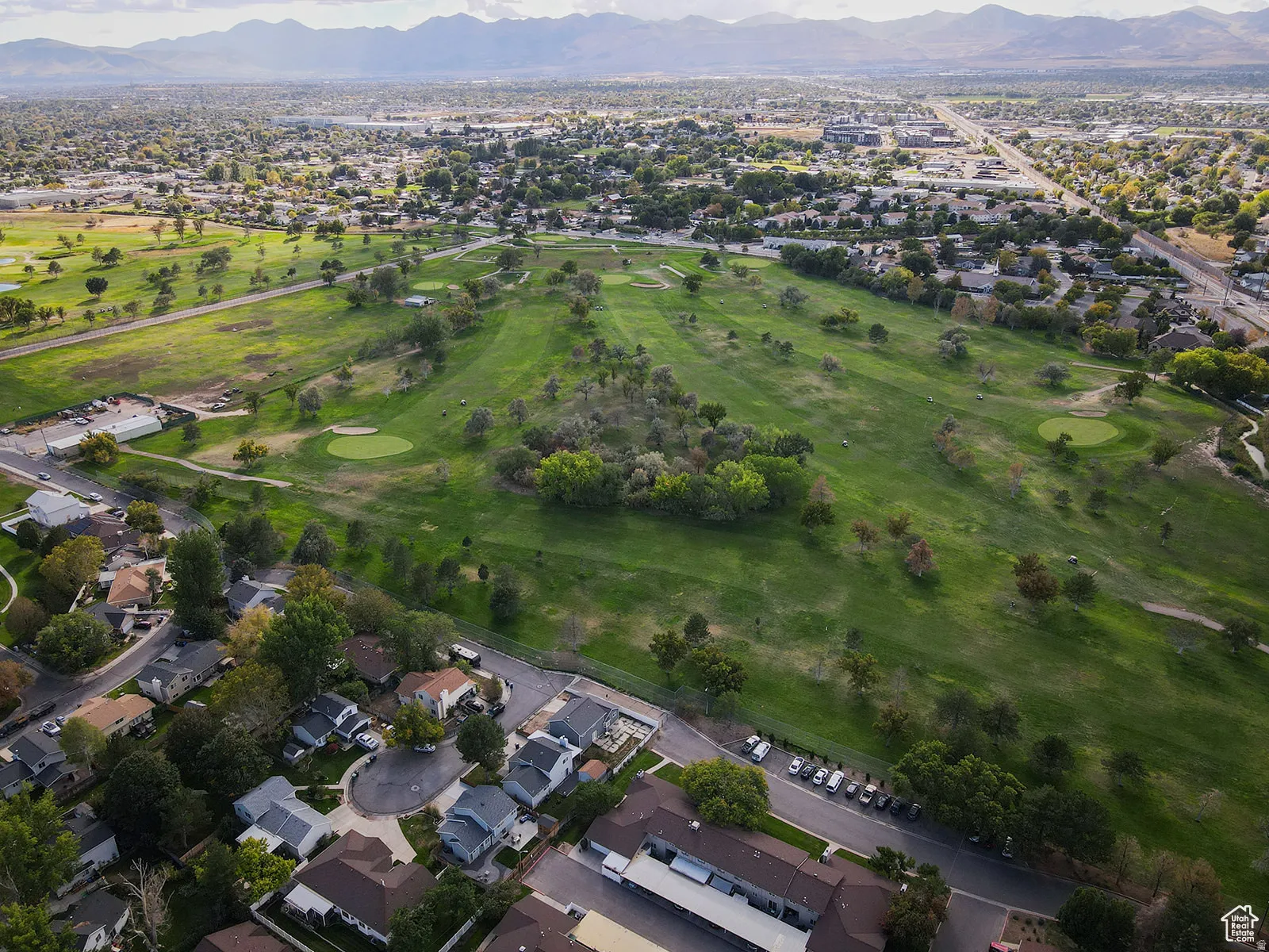 Expansive golf course with manicured greens and mature trees