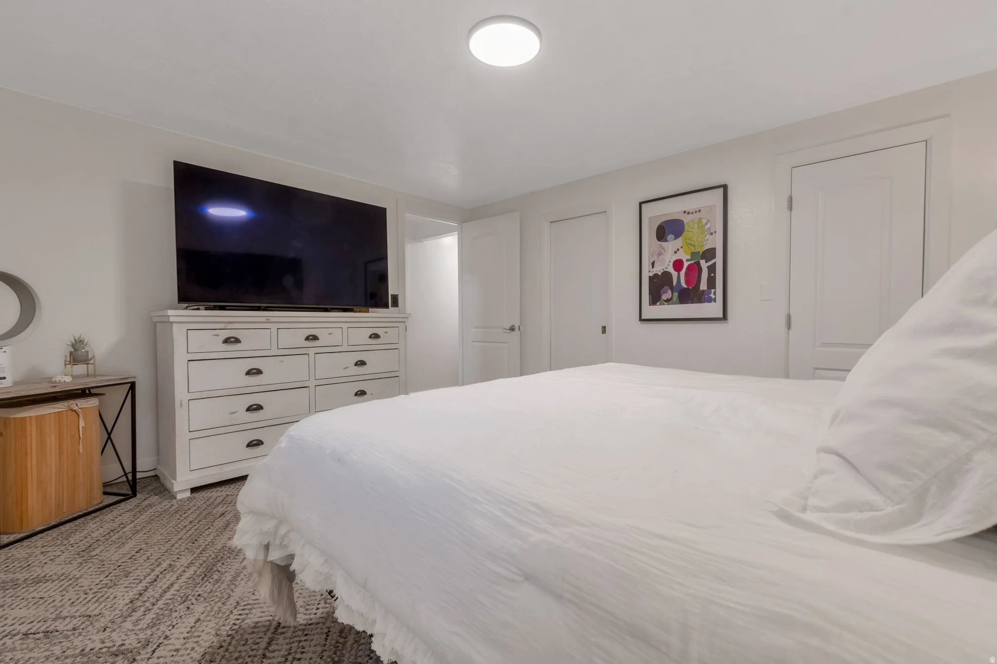 Recessed ceiling lighting, two panel doors, and neutral wall paint