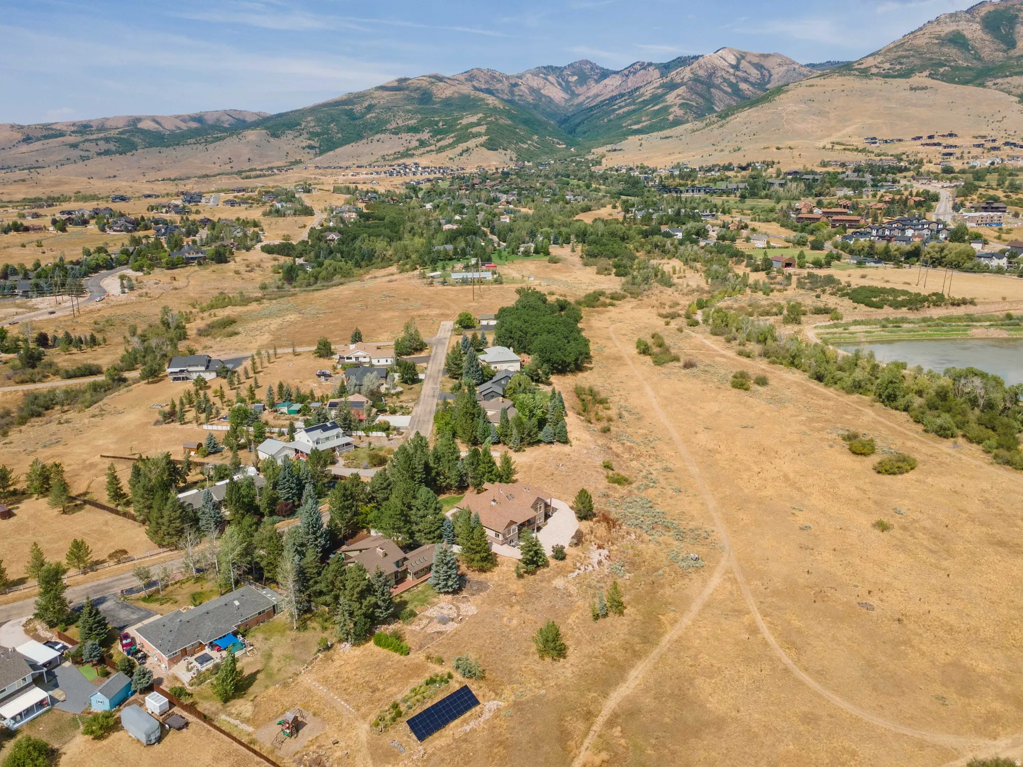 Expansive properties with a mountainous backdrop, mature trees, and natural landscaping