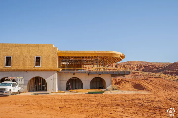 Architectural design featuring multiple arched openings, concrete foundation, and a wood-framed upper level