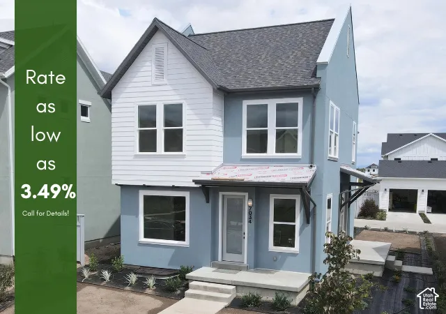 Two-story exterior with a combination of light blue stucco and white horizontal siding