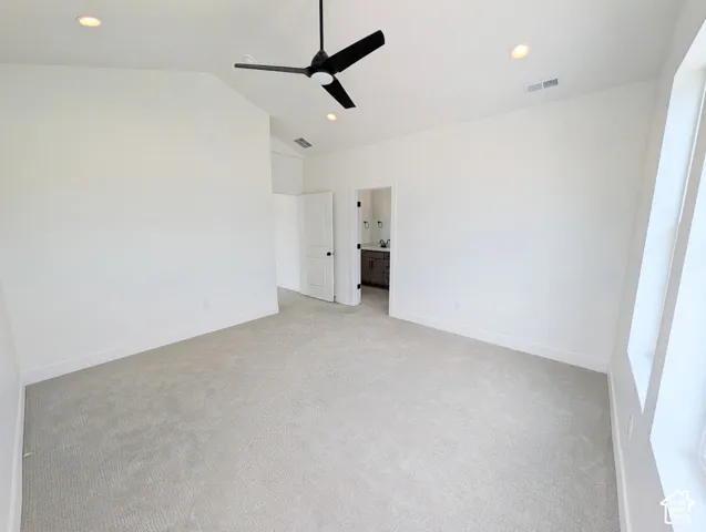 Vaulted ceiling with recessed lighting and a black ceiling fan