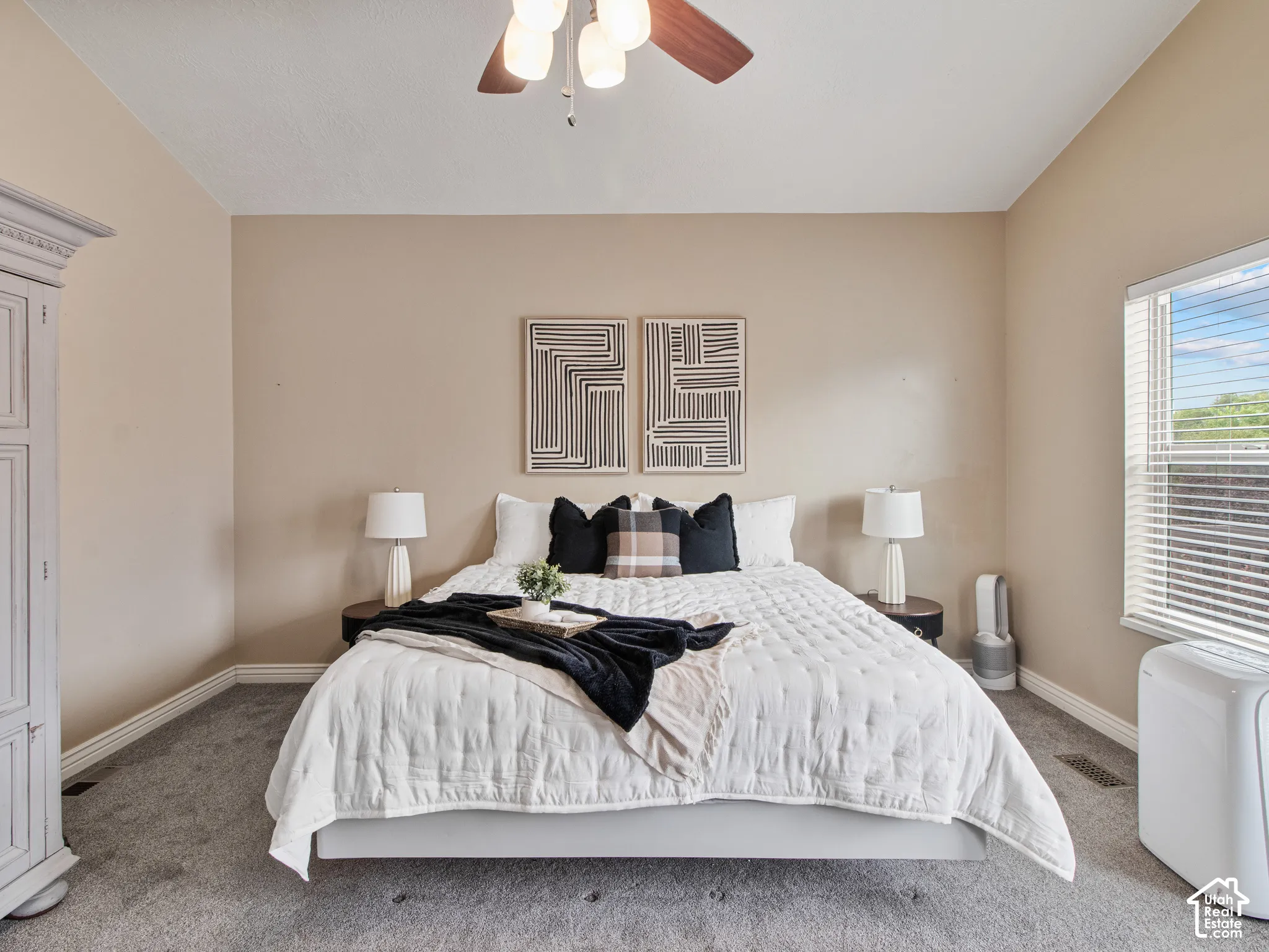 Spacious room, Wall-to-wall carpeting, window with blinds, ceiling fan, and crown molding details