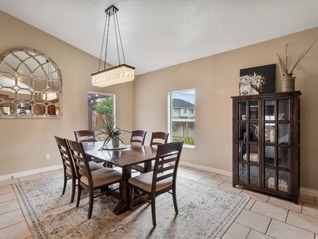 Plenty of space for a big family or guest. Recessed lighting, tiled flooring, and a contemporary linear chandelier with crystal accents