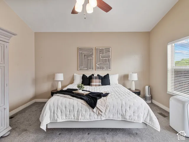 Spacious room, Wall-to-wall carpeting, window with blinds, ceiling fan, and crown molding details