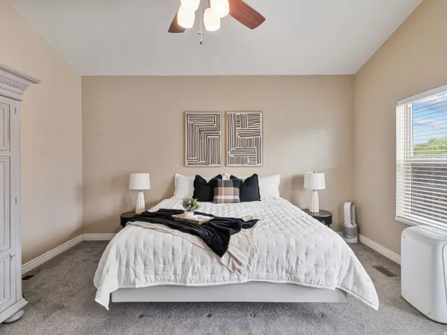 Spacious room, Wall-to-wall carpeting, window with blinds, ceiling fan, and crown molding details