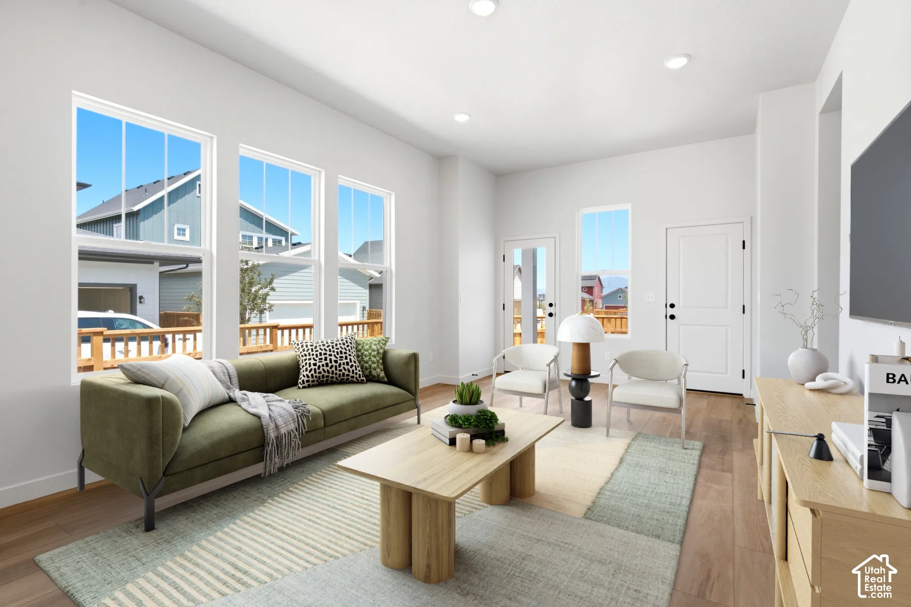 Wood-finish flooring, recessed lighting, and white trim