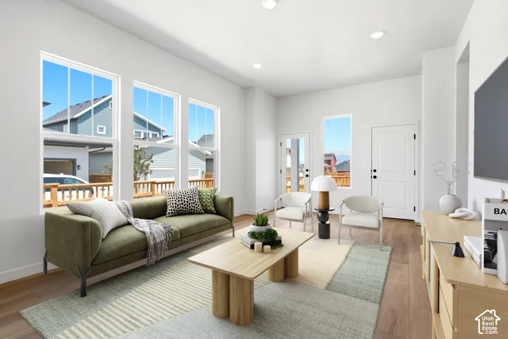 Wood-finish flooring, recessed lighting, and white trim