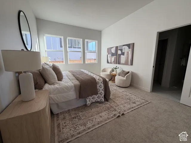 Triple window unit, neutral carpet flooring, light wall tones, recessed lighting, and a white interior door