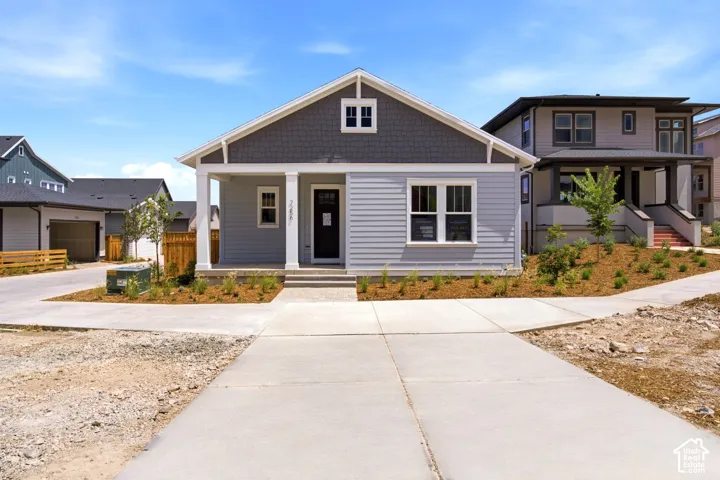 Light-colored siding exterior with a contrasting dark gray shingle accent