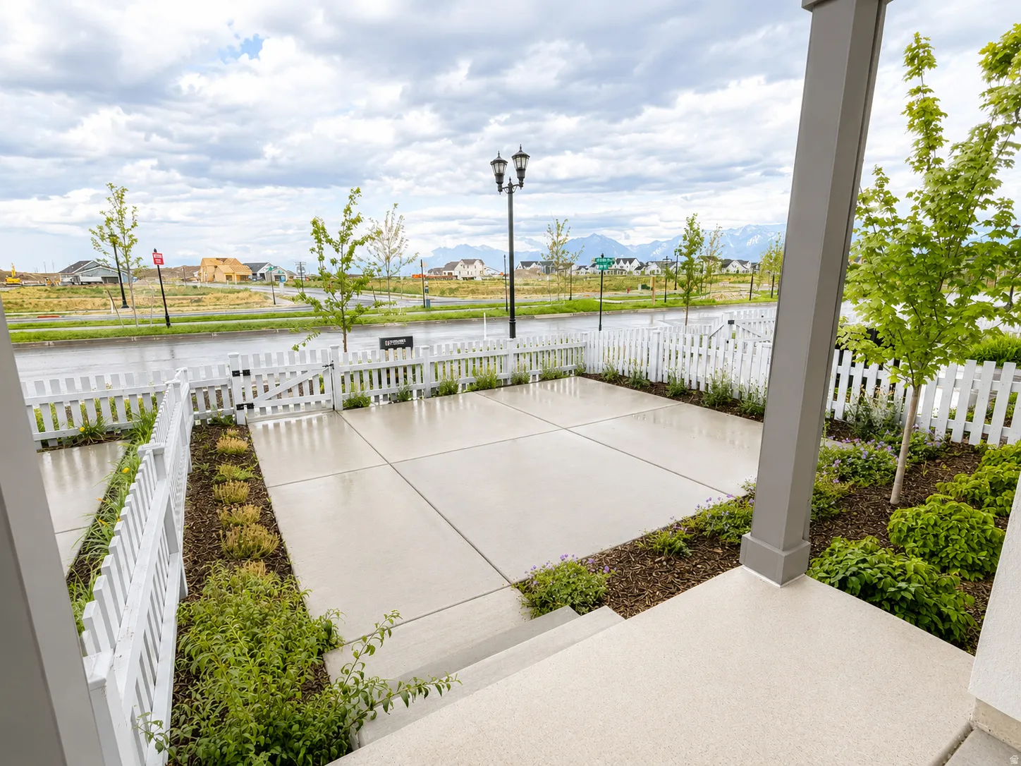Fenced in front yard with concrete patio