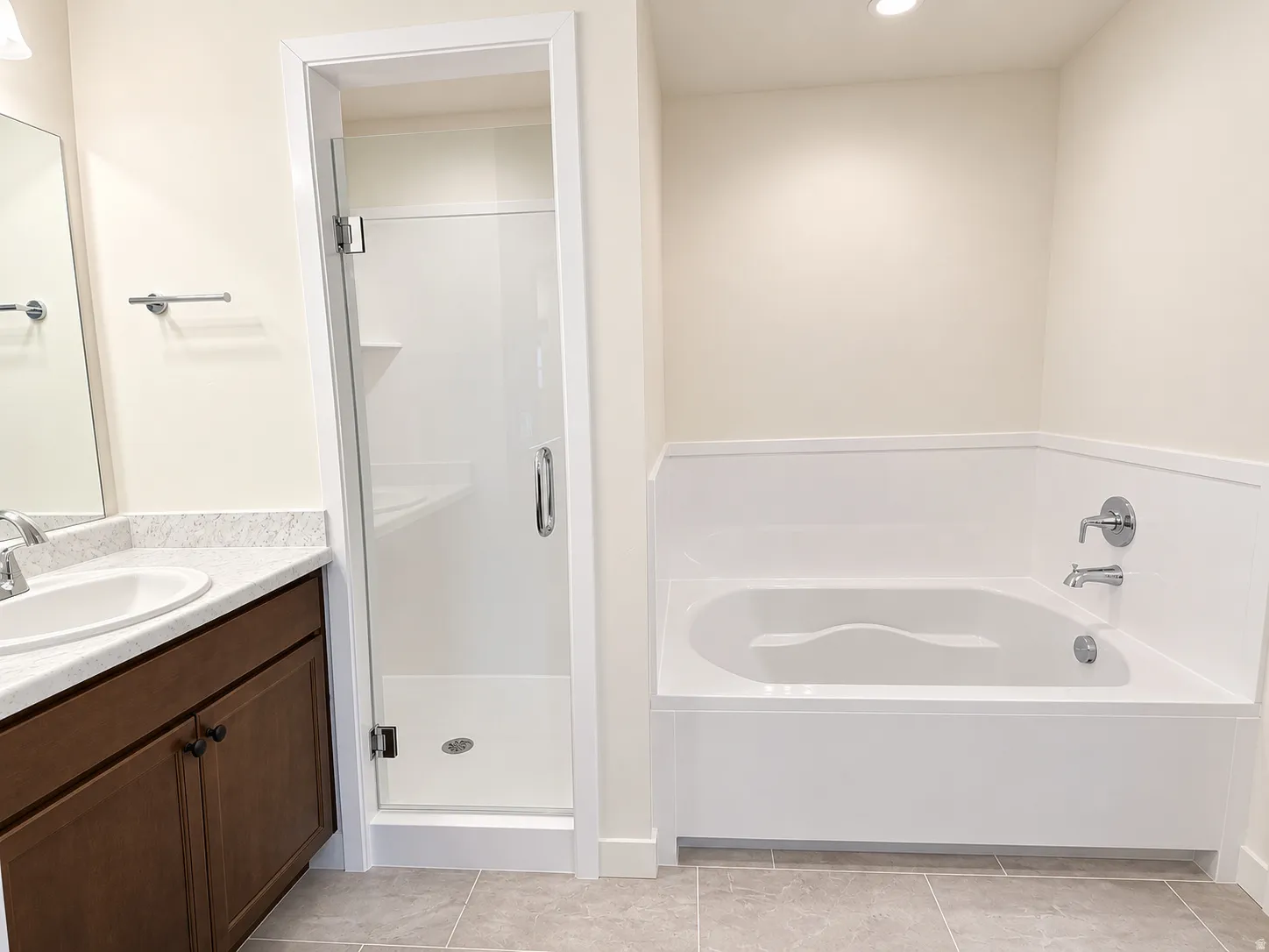 Primary bathroom with separate tub and shower with 2 vanities