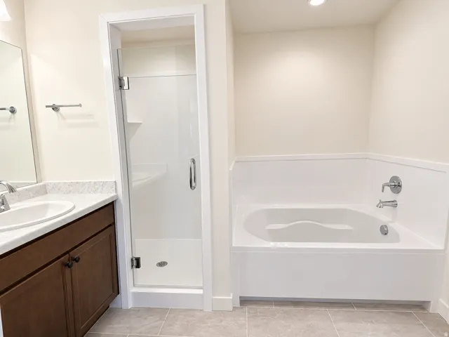 Primary bathroom with separate tub and shower with 2 vanities
