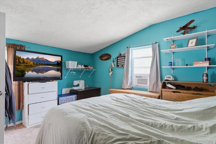 Carpeted flooring with a textured ceiling