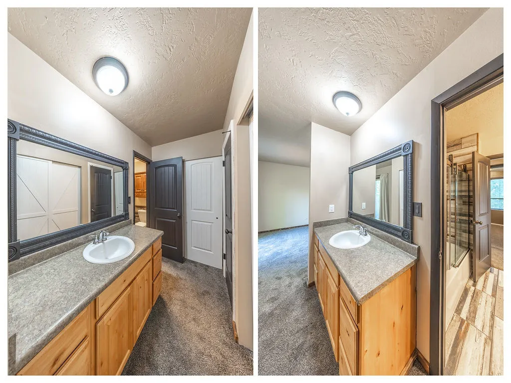 Double vanity with natural wood cabinetry and a framed mirror