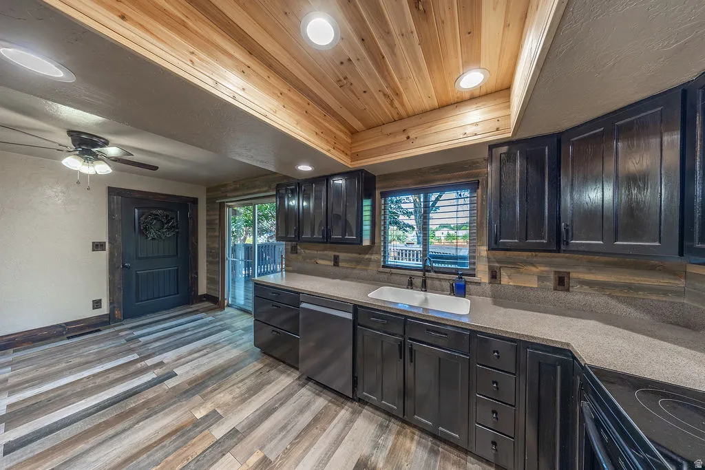 Kitchen featuring wood-finish flooring and a wood plank ceiling with recessed lighting