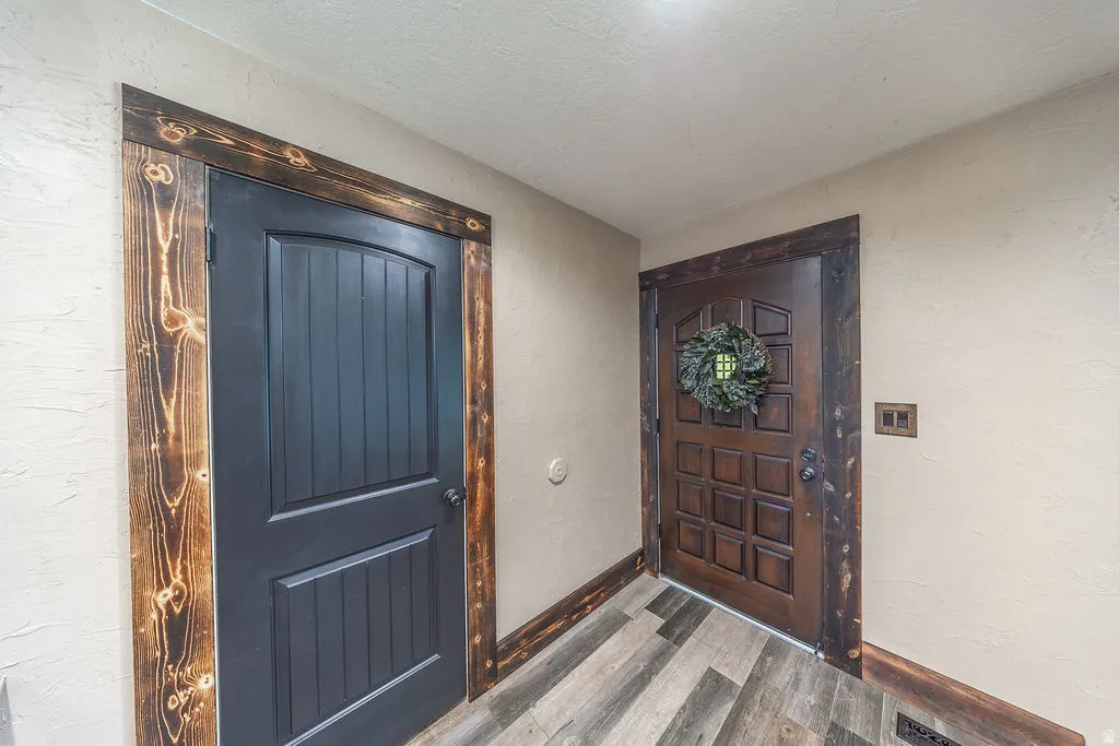 Wood-finish flooring complementing distressed wood door trim
