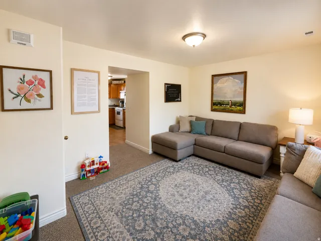 Recessed lighting, carpet flooring, a cased opening, and neutral wall paint