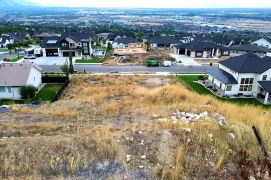 Graded lot with partial clearing, surrounded by established residential properties