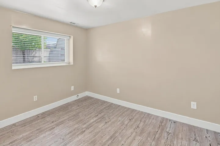 Bedroom #5.  Room with neutral-toned walls and wood-finish flooring
