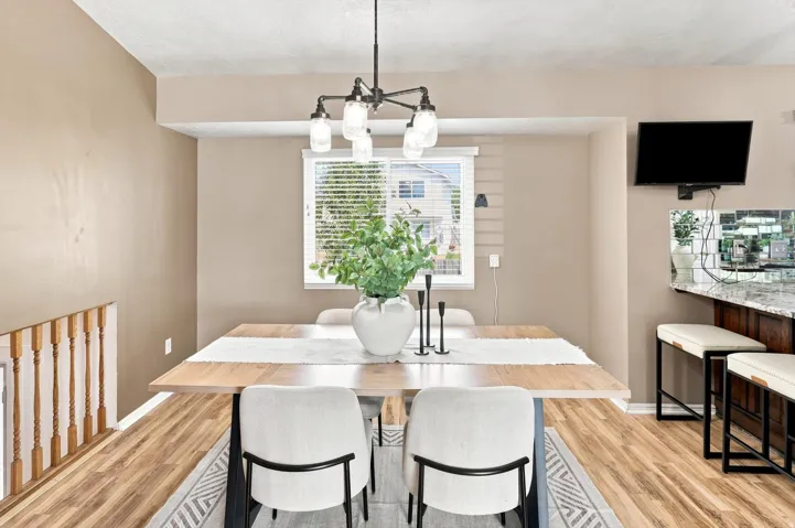 Spacious dining area with modern lighting and window for natural light